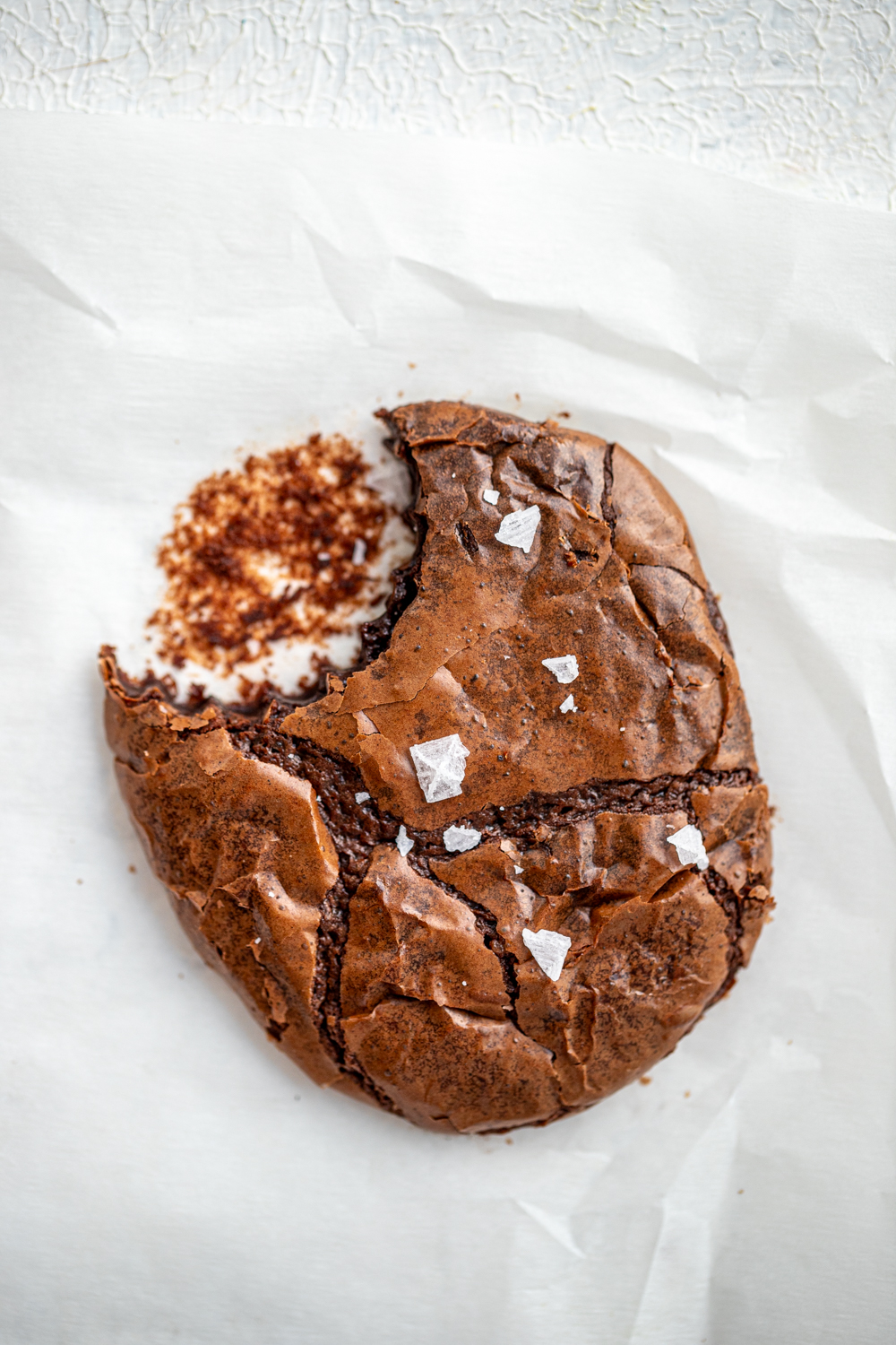 Top shot about a bitten salted chocolate brownie cookie