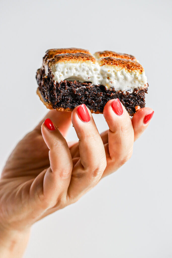 Layered gianst smores brownie with cracker, fudgy brownie and golden giant marshmallow