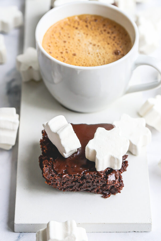 fudgy hot chocolate brownies full batch with star marshmallows and a mug of hot cocoa.