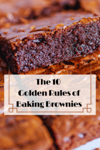 Close-up of a perfectly cut fudgy brownie square showing the dense, moist interior texture and the signature shiny, crackly crust.